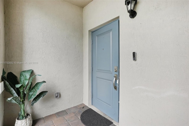 property entrance featuring stucco siding