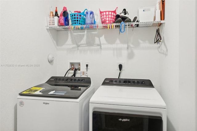 clothes washing area with laundry area and washer and clothes dryer