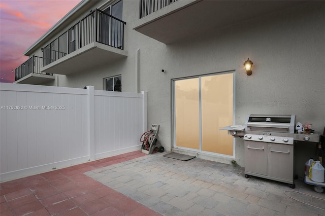 view of patio / terrace with fence and a grill