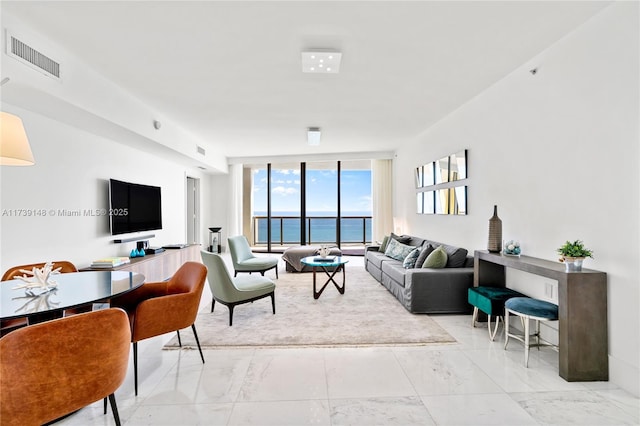 living room with floor to ceiling windows, visible vents, and marble finish floor