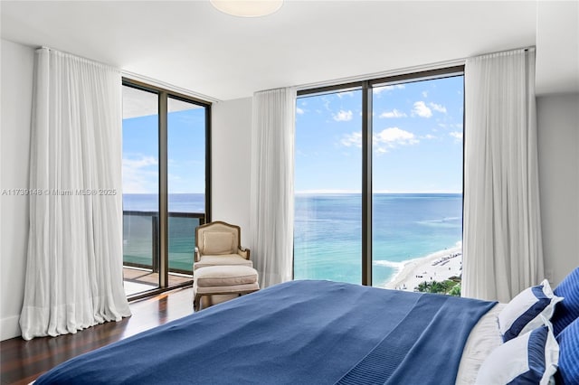 16275 Collins Ave Unit 1501, Sunny Isles Beach, FL 33160 - bedroom featuring a water view, multiple windows, access to outside, expansive windows, and wood finished floors