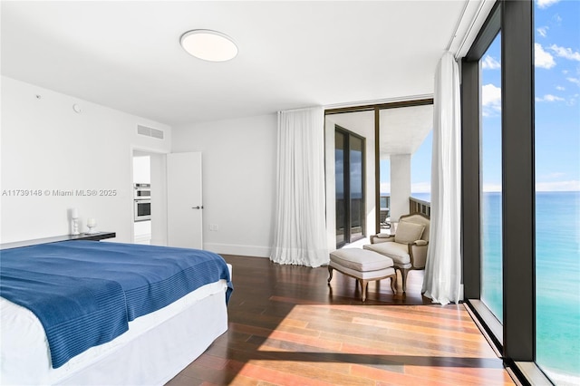 16275 Collins Ave Unit 1501, Sunny Isles Beach, FL 33160 - bedroom featuring a wall of windows, visible vents, baseboards, and wood finished floors