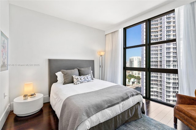 16275 Collins Ave Unit 1501, Sunny Isles Beach, FL 33160 - bedroom with multiple windows, a city view, wood finished floors, and floor to ceiling windows