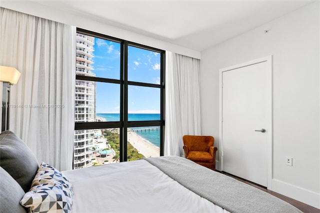 16275 Collins Ave Unit 1501, Sunny Isles Beach, FL 33160 - bedroom with baseboards and a water view