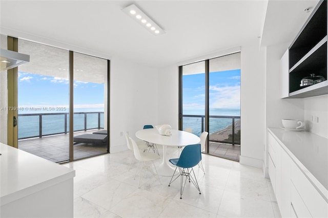 16275 Collins Ave Unit 1501, Sunny Isles Beach, FL 33160 - dining room featuring a healthy amount of sunlight, a wall of windows, and a water view