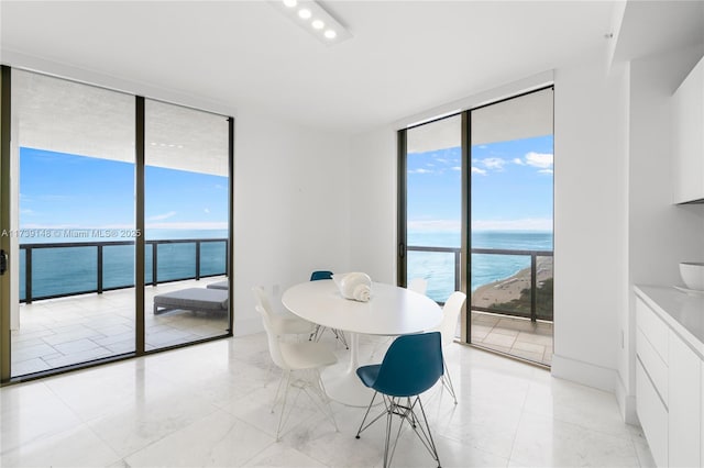 16275 Collins Ave Unit 1501, Sunny Isles Beach, FL 33160 - dining space featuring floor to ceiling windows, baseboards, and a water view