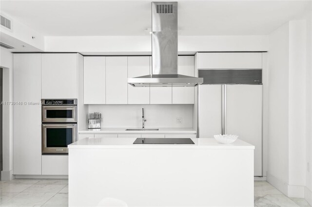 16275 Collins Ave Unit 1501, Sunny Isles Beach, FL 33160 - kitchen featuring island range hood, stainless steel double oven, marble finish floor, modern cabinets, and a sink