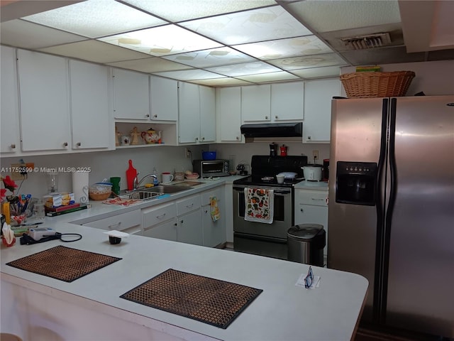 kitchen with open shelves, stainless steel appliances, light countertops, white cabinets, and under cabinet range hood