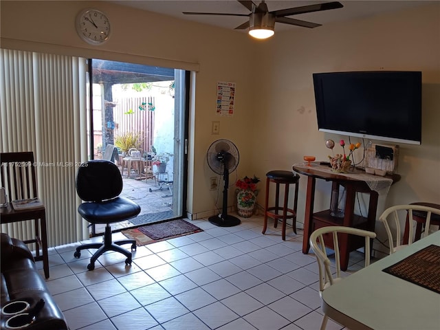 interior space featuring light tile patterned flooring and a ceiling fan