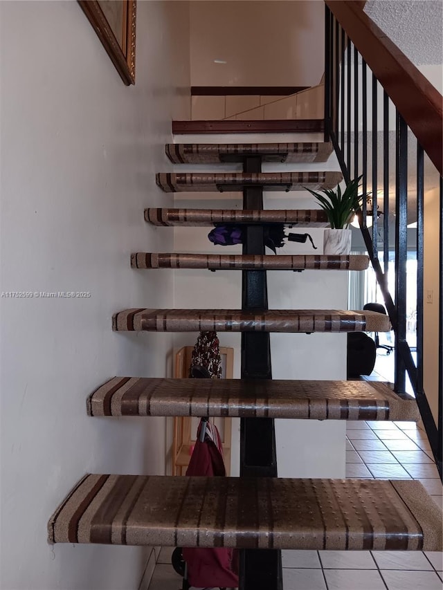 staircase with tile patterned floors