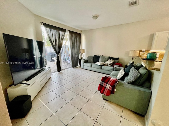 living area featuring visible vents and light tile patterned flooring