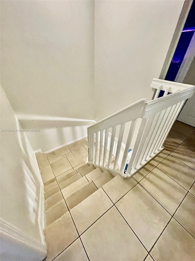 stairs with tile patterned floors