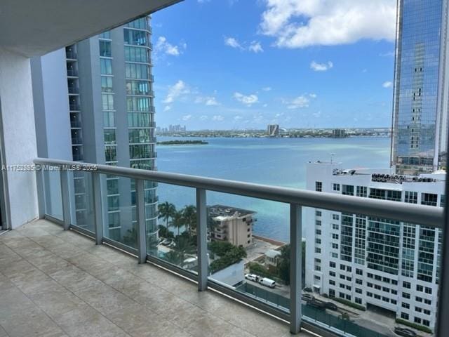 balcony with a water view and a city view