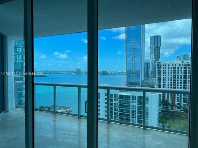 balcony with a water view and a city view