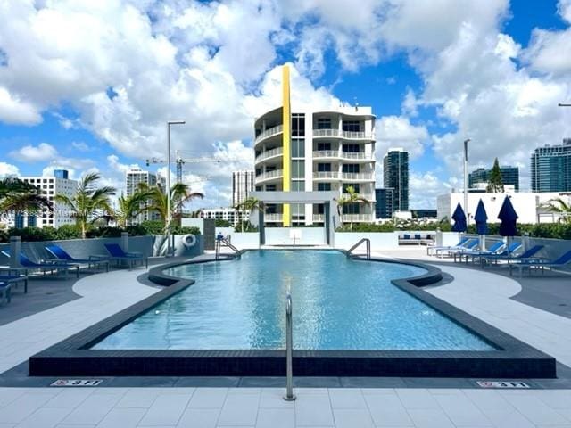 pool featuring a patio area and a city view