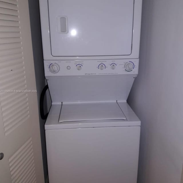 clothes washing area with laundry area and stacked washer / dryer