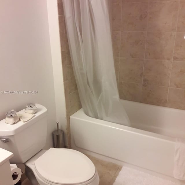 bathroom with toilet, shower / tub combo, and tile patterned floors