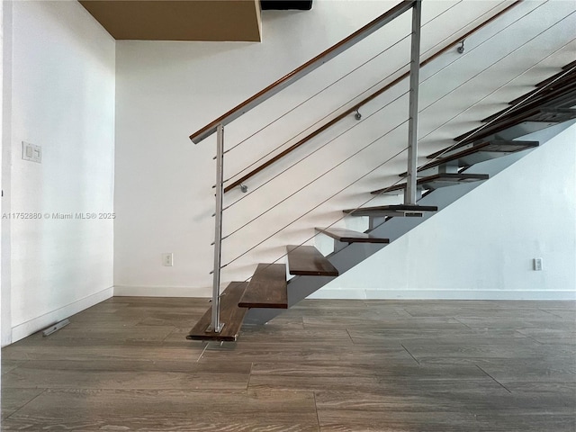 stairs featuring baseboards and wood finished floors