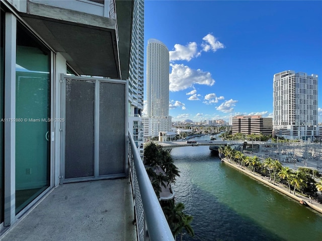 balcony featuring a view of city and a water view