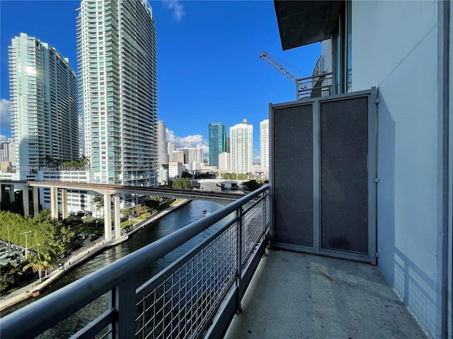 balcony with a water view and a city view