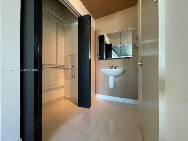 bathroom featuring baseboards and tile patterned floors