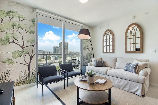 living room featuring a view of city, expansive windows, and visible vents