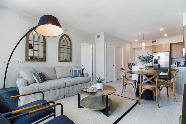 living room featuring recessed lighting and visible vents