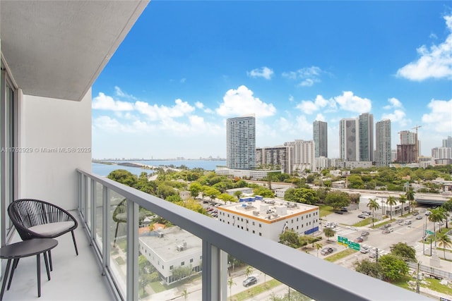 balcony with a water view and a city view