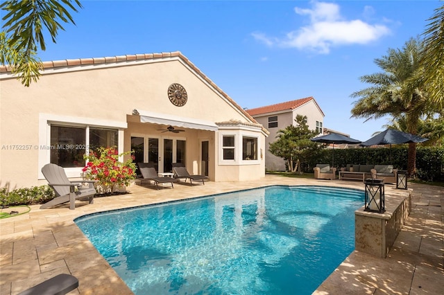 view of swimming pool with an outdoor hangout area, a patio area, a fenced in pool, and a ceiling fan