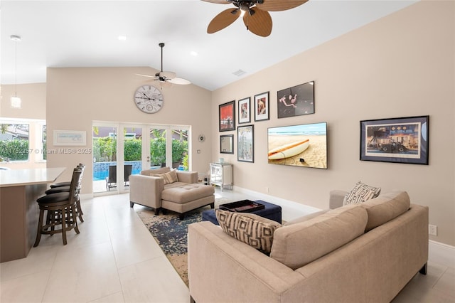 living area featuring french doors, light tile patterned flooring, ceiling fan, high vaulted ceiling, and baseboards