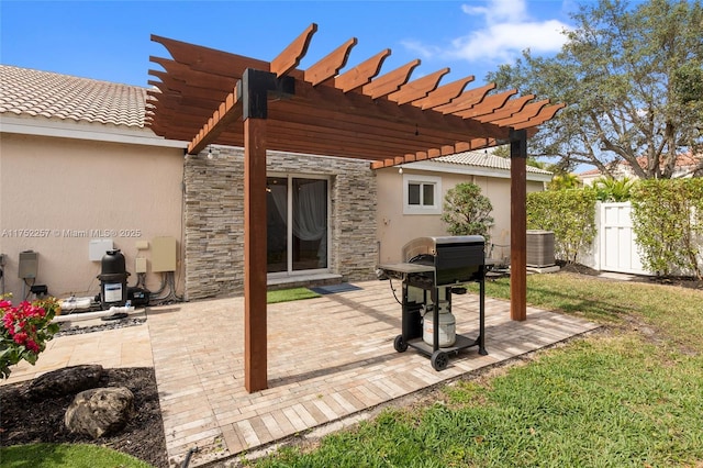 view of patio featuring central AC unit, fence, and a pergola