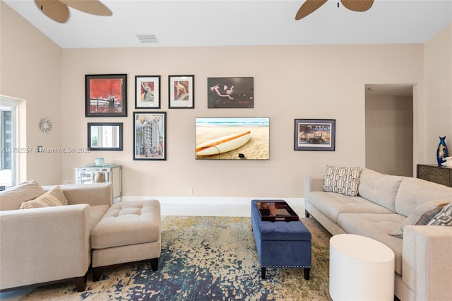 living room with a ceiling fan and visible vents