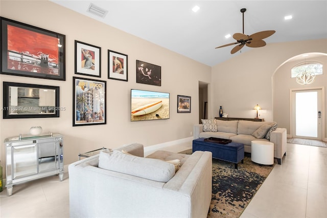 living area featuring light tile patterned floors, vaulted ceiling, visible vents, and recessed lighting