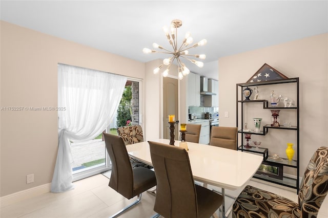 dining area with baseboards, light tile patterned flooring, and an inviting chandelier