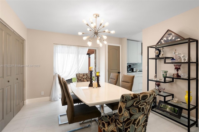 dining area with a notable chandelier, baseboards, and light tile patterned floors