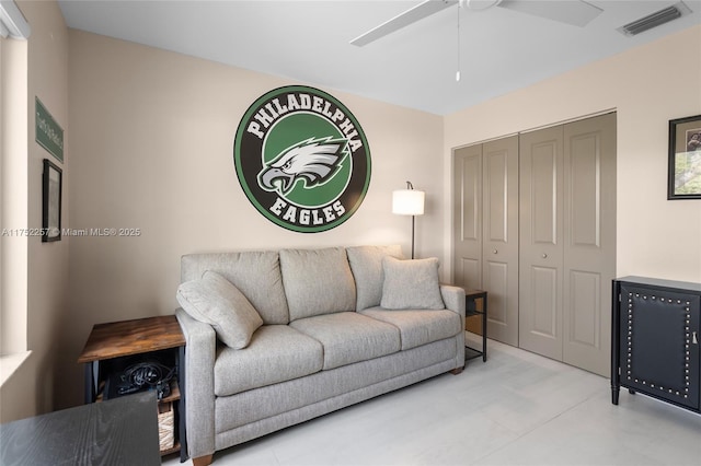 living room with a ceiling fan and visible vents