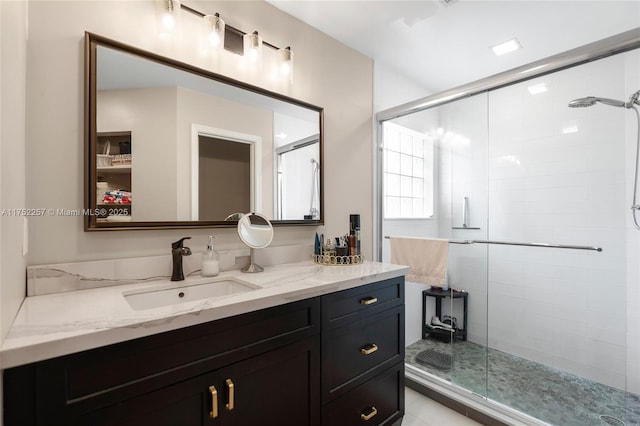 full bath with a shower stall and vanity