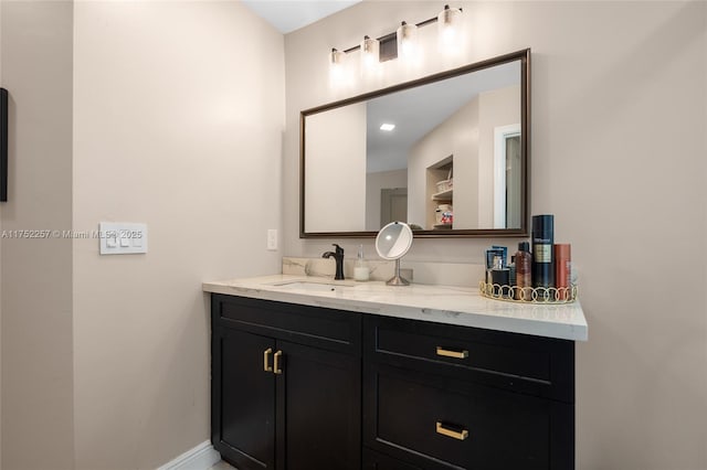 bathroom with vanity and baseboards