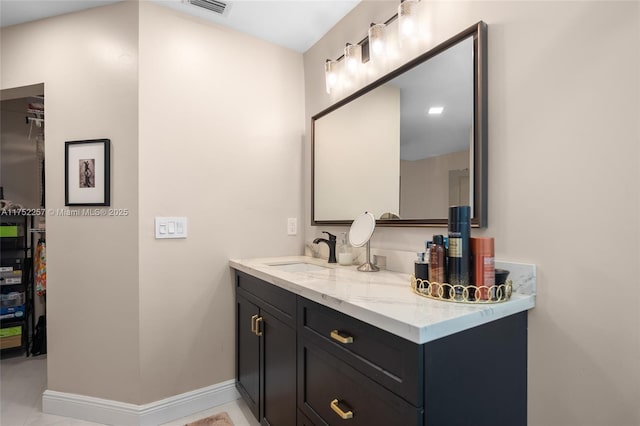 bathroom with visible vents, baseboards, and vanity