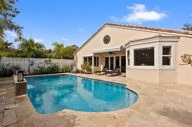 view of pool with a patio area, a fenced backyard, a ceiling fan, and a fenced in pool