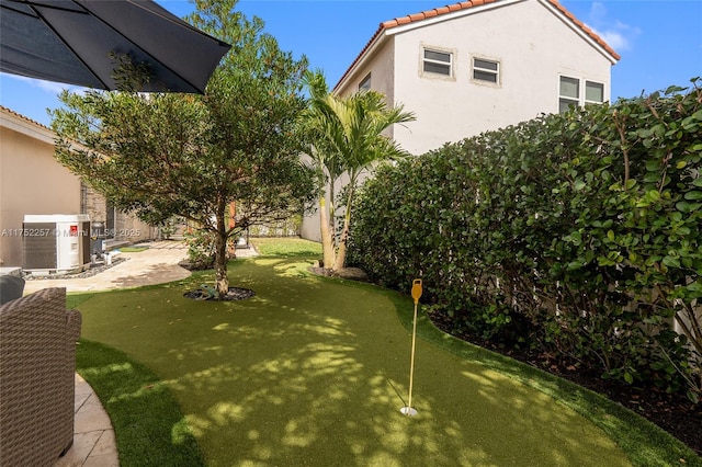 view of yard featuring a patio area, a fenced backyard, and central air condition unit