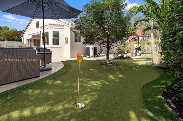 view of yard featuring cooling unit and fence