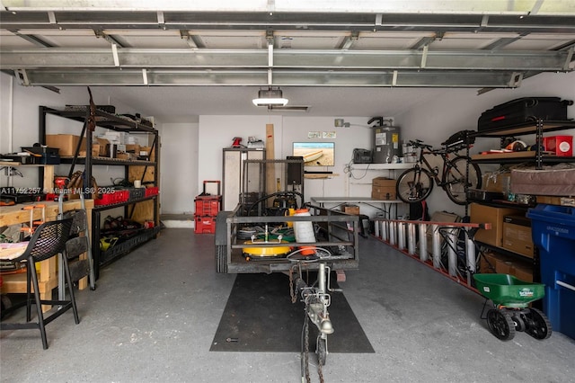 garage featuring water heater, a workshop area, and a garage door opener