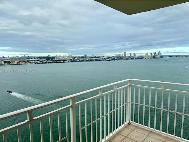 balcony with a water view and a city view