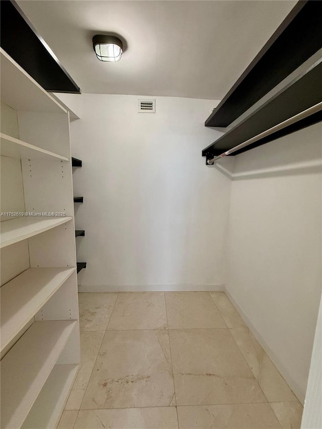 walk in closet with visible vents