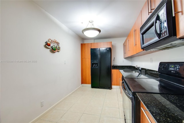 kitchen featuring brown cabinetry, a sink, and black appliances