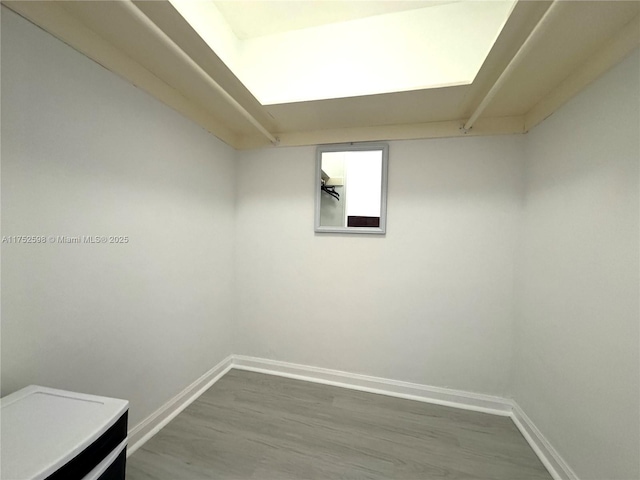 interior space featuring baseboards and wood finished floors