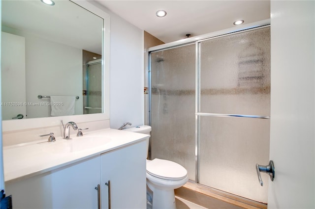 full bath featuring toilet, a shower stall, recessed lighting, and vanity