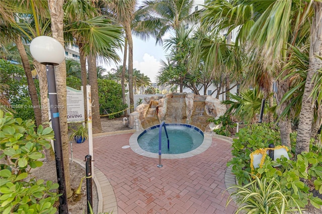 view of swimming pool with a patio area and a hot tub