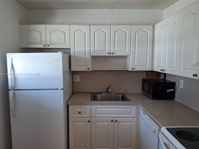 kitchen featuring light countertops, white appliances, white cabinets, and a sink